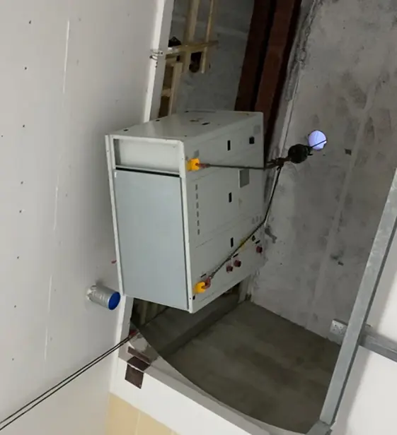 A Liftroller unit parked in a stripped back interior with bare concrete and new plasterboard